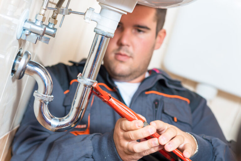 Photo of plumber in sandy springs repairing drain.