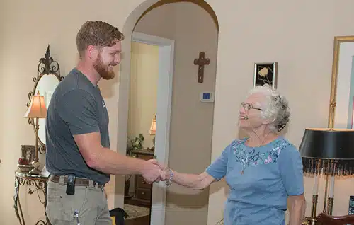 Fix & Flow Plumber Shaking Older Atlanta Woman's Hand