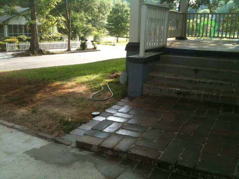 New Sewer Line Installed with Cleanout. Trench Backfilled. Front Porch Landing Pavers Reset.