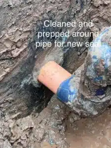 Fix & Flow Atlanta plumber cleaning and prepping sewer pipe around joint for new seal installation