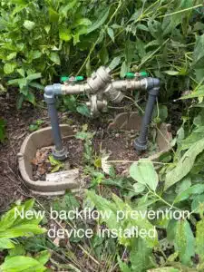 Fix & Flow Atlanta plumber installs new backflow prevention device with PVC pipes and brass valves